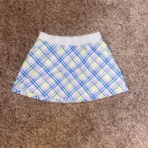 This is a DSG golf skirt that is very colorful in a youth Large